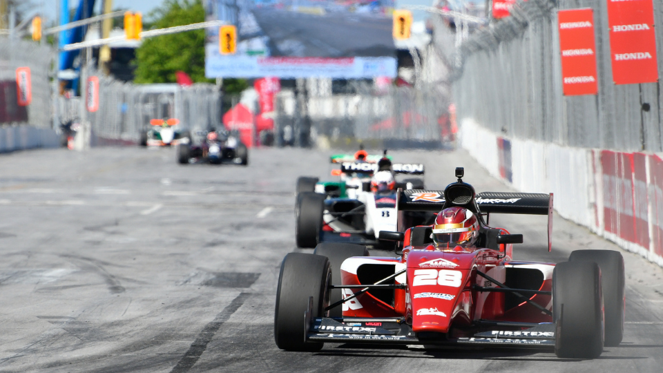 Indy Lights car through turn 1 at the Honda Indy Toronto