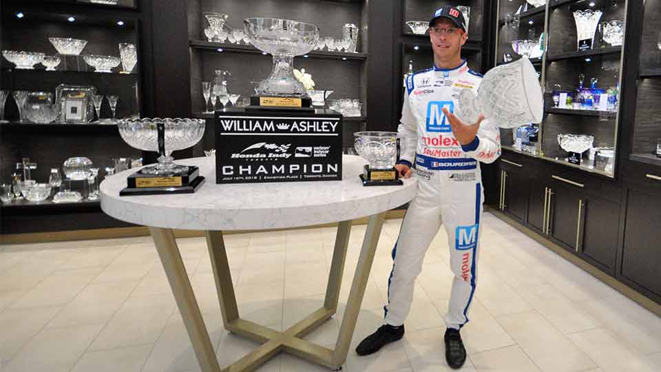 Sebastien Bourdais drops an imitation trophy during the reveal